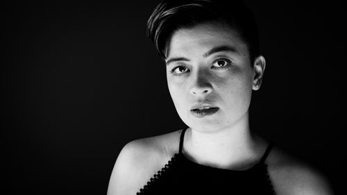 Free A captivating black and white portrait of a young adult with short hair, emphasizing expression and emotion. Stock Photo
