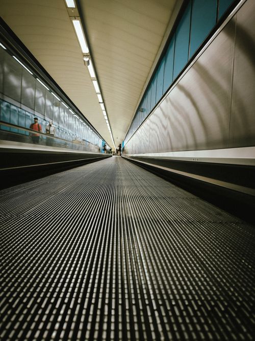 Free Dramatic low-angle view of a modern tunnel in Madrid airport, capturing motion and symmetry. Stock Photo