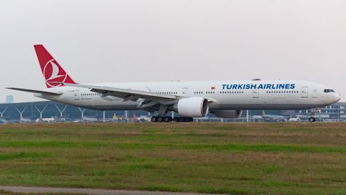 Free Turkish Airlines Boeing 777 aircraft on runway at airport taxiing for takeoff. Stock Photo
