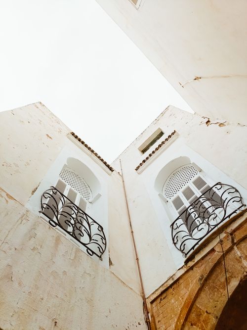 Free Dynamic perspective of traditional Tunisian buildings in Tunis, featuring intricate ironwork balconies. Stock Photo