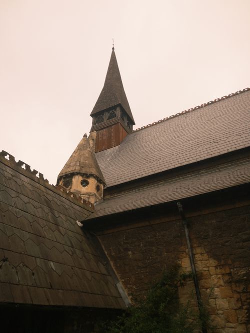Free Upward view of a historic church with intricate architectural details highlighted by a tall steeple. Stock Photo