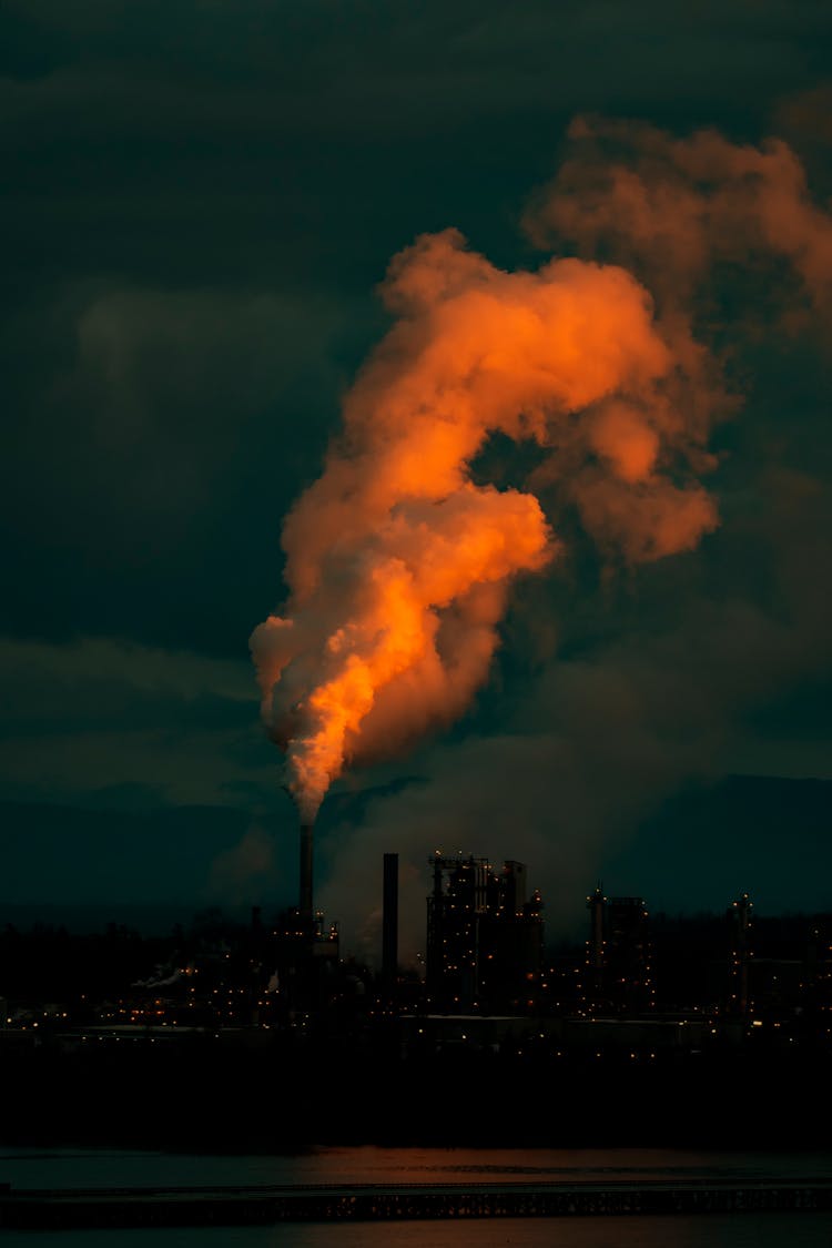 Colorful Smoke From Chimney In City At Night