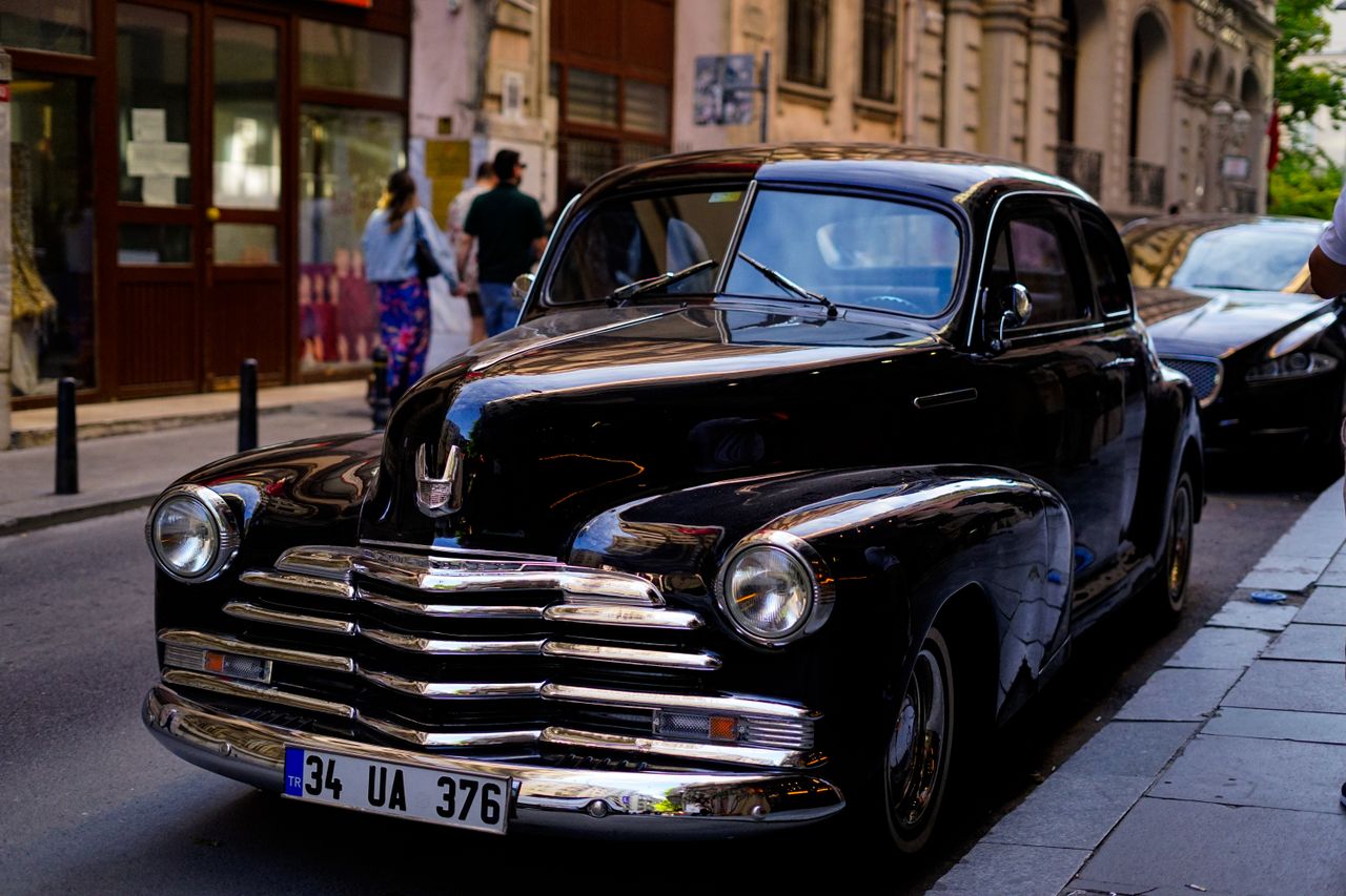 vintage black car parked on a european street with a classic design an