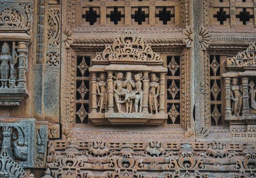 Free Detailed view of ornate stone carvings on an ancient Indian temple facade showcasing cultural heritage. Stock Photo