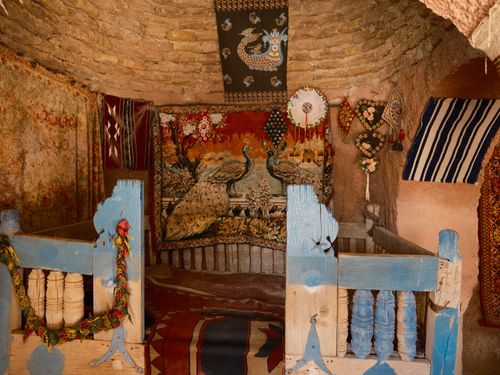 Free A rustic interior in Şanlıurfa, Türkiye, featuring ornate tapestries and traditional decor. Stock Photo