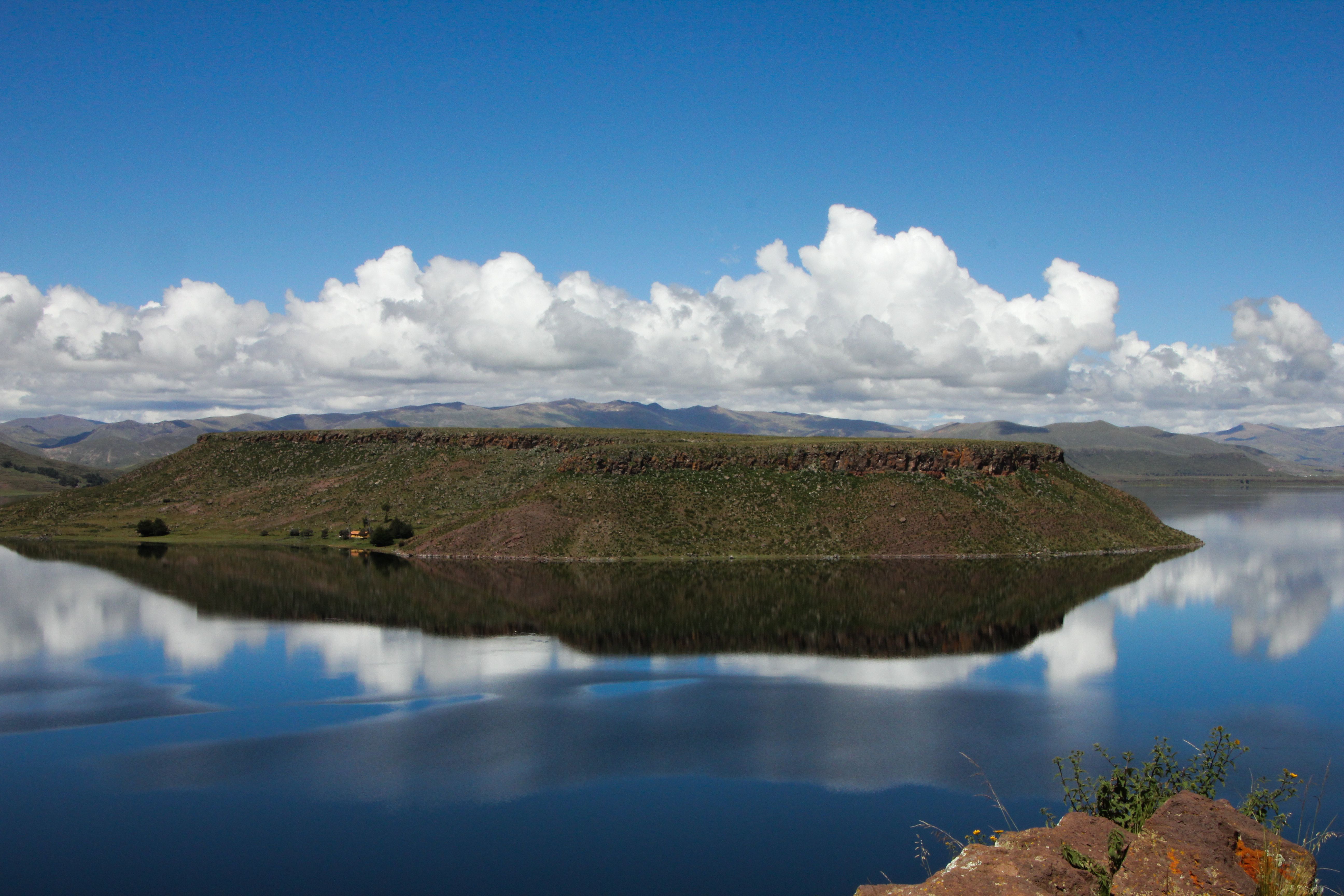 Serene landscape of Lake Umayo and Sillustani reflecting clouds, Puno, Peru. - Puno