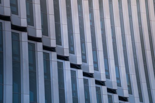 Free Close-up view of a modern building facade with reflective glass windows in Putrajaya, Malaysia. Stock Photo