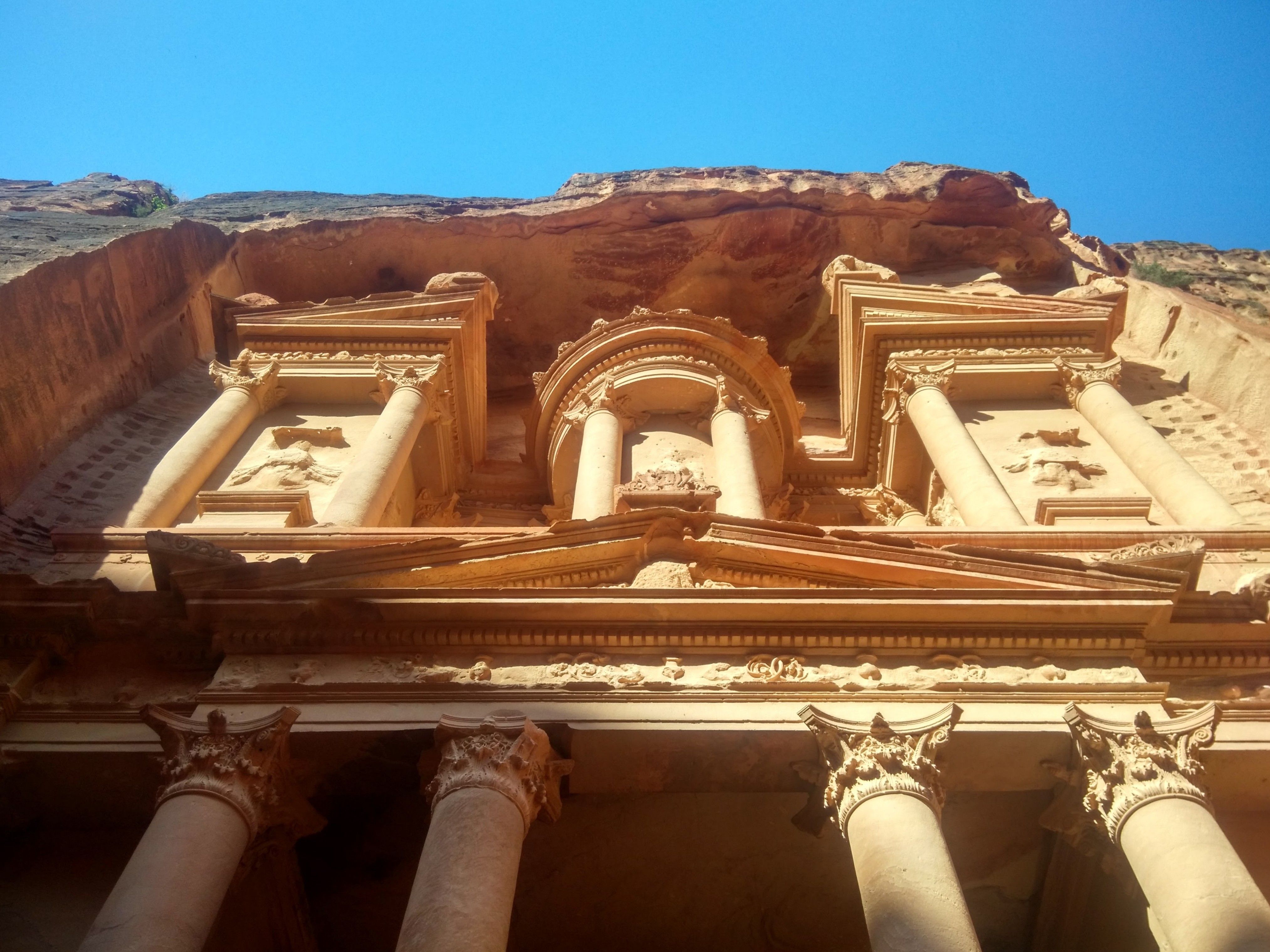 The Treasury at Petra, Jordan, under a clear blue sky, ideal for exploring