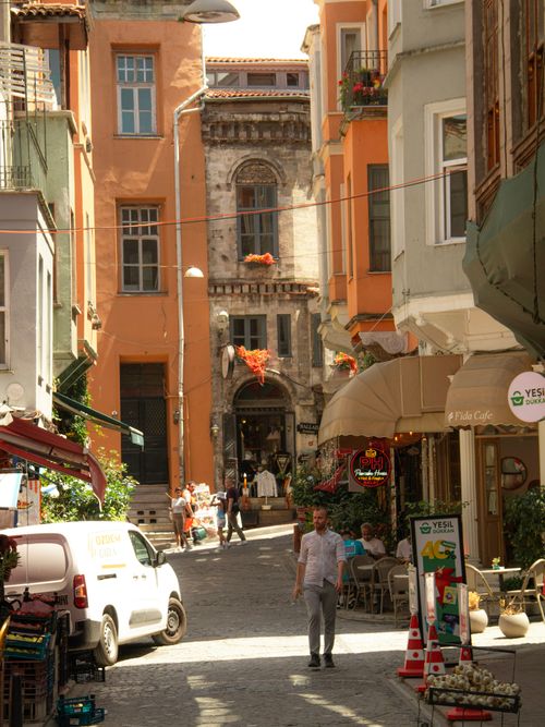 Free A vibrant street in Istanbul lined with colorful buildings and cafes, bustling with activity. Stock Photo