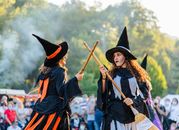 Two women dressed as witches perform at an outdoor festival in Sant Joan les Fonts, España.