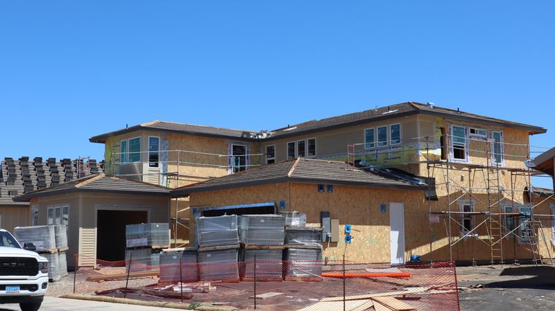 Home addition under construction with fresh framing and scaffolding