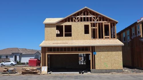Free Framed house under construction in Elk Grove, showing modern building techniques on a sunny day. Stock Photo