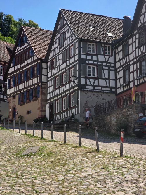 Free A picturesque view of traditional half-timbered houses along a sunny cobblestone street. Stock Photo