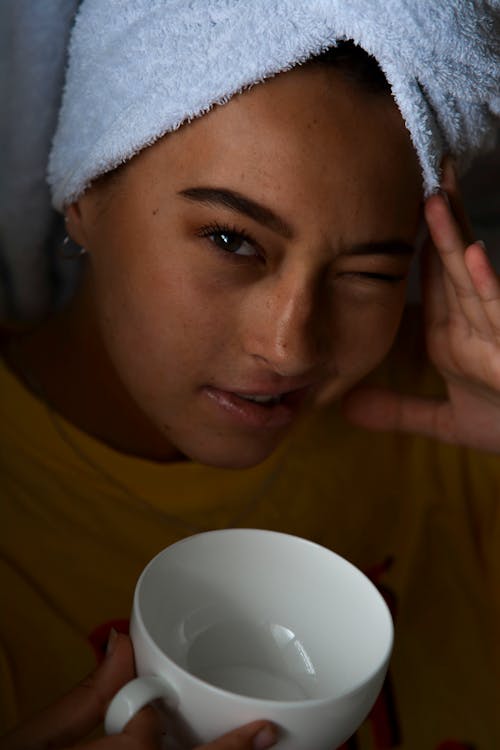 Woman in Yellow Shirt Holding White Ceramic Mug