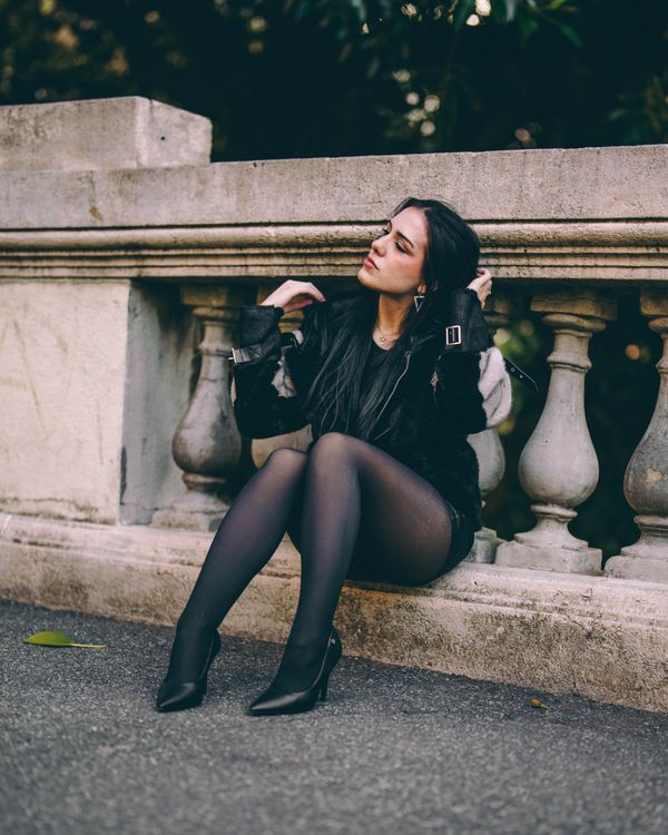 Stone Railing Sitting Contemplative Woman Sitting on Urban Stone Railing · Free Stock Photo