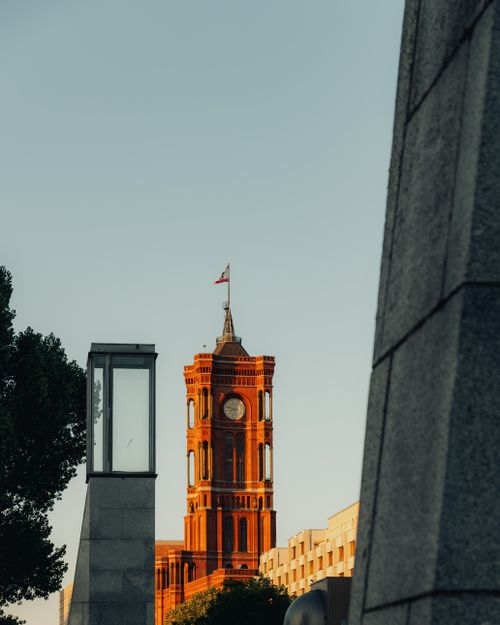 Free View of Rotes Rathaus in Berlin with warm sunset lighting, highlighting the iconic architecture. Stock Photo