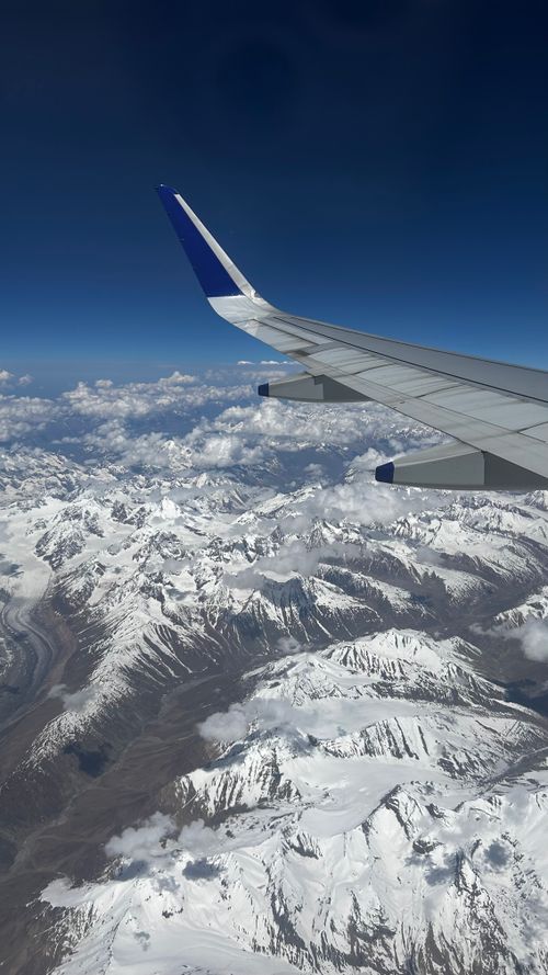 Free Stunning aerial view of the snow-capped Himalayan mountain range from an airplane window. Stock Photo
