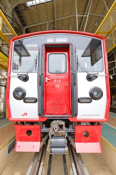 Close-up of 815 series train front in Kitakyushu depot showcasing railway engineering.