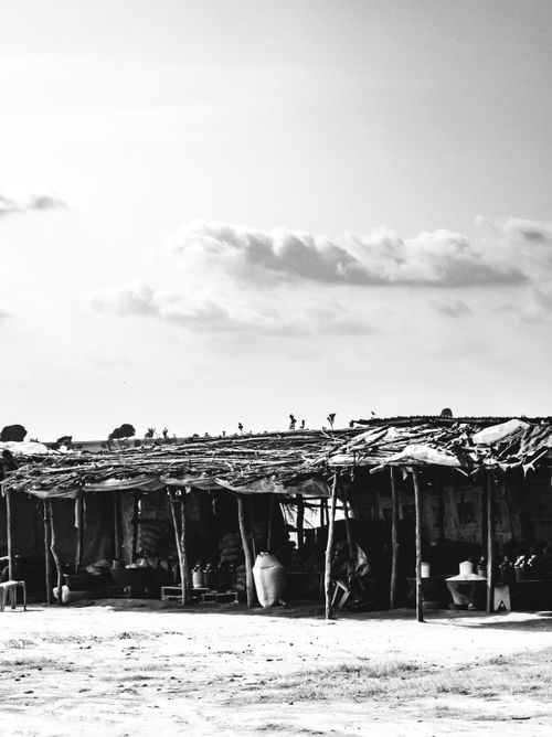 Free Black and white photo of a rural market structure under cloudy sky in Abuja, Nigeria. Stock Photo