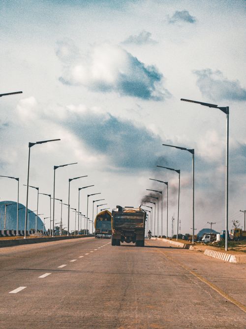 Free A highway scene in Abuja, Nigeria, featuring a truck under a cloudy sky. Stock Photo