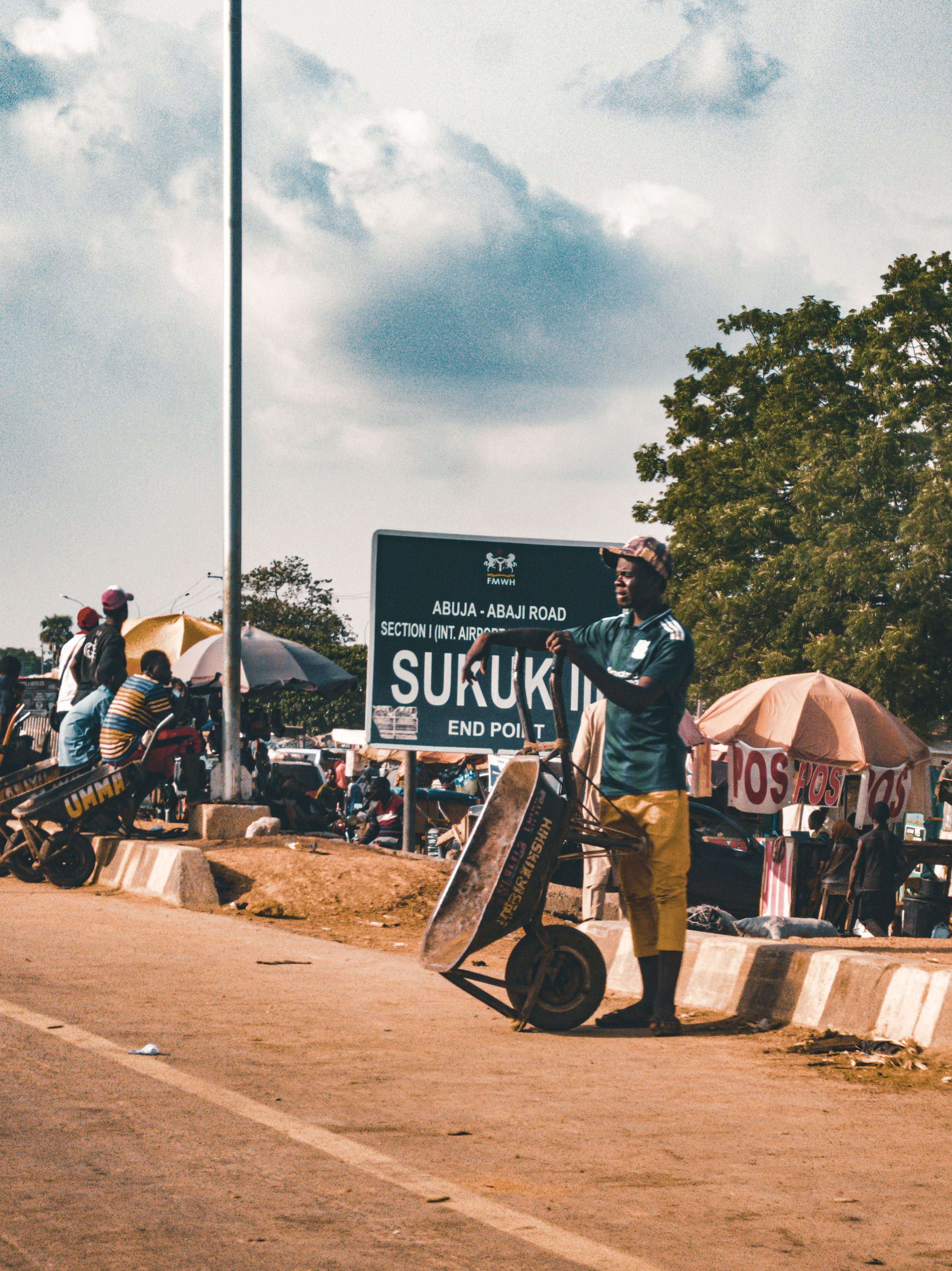 Vibrant street life captured at Suruki's intersection in Abuja, Nigeria.