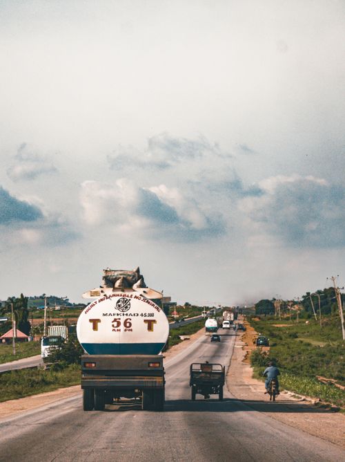 Free A vibrant rural highway with vehicles in motion under a dramatic sky in Abuja, Nigeria. Stock Photo