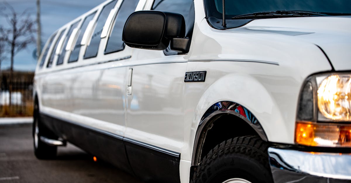 Photo by Brett Sayles Elegant white limousine parked on the street, showcasing luxury transportation.