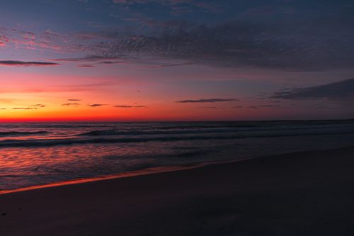 Free Vibrant sunset over the beach in Quảng Trị, Vietnam, with colorful skies and gentle waves. Stock Photo