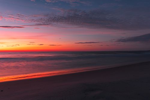 Free A beautiful sunset over Quang Tri beach with vibrant sky colors and calm sea. Stock Photo