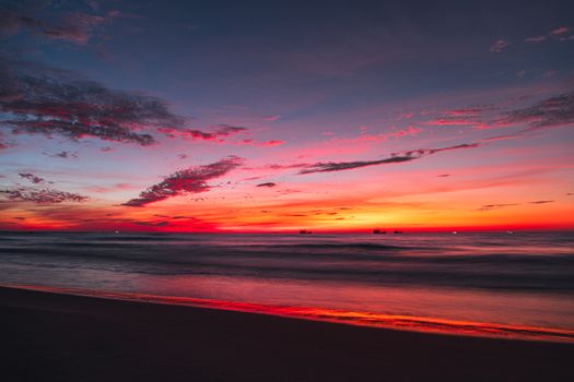 Stunning sunset with vivid colors over a serene beach in Quảng Trị, Vietnam.