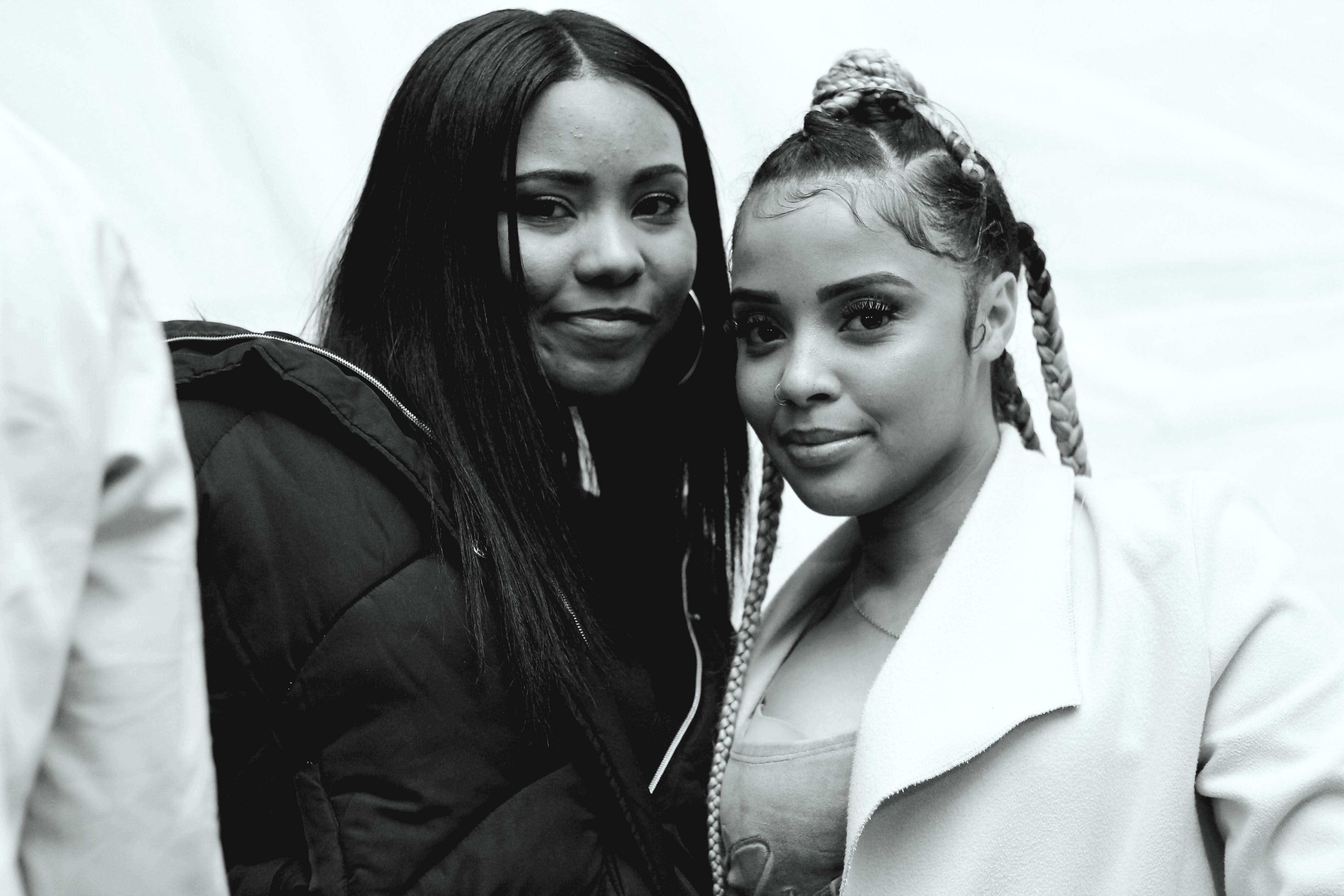 Black and white photo capturing a candid moment of two women smiling in Soweto, South Africa.