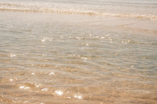 Serene ocean waves glistening in sunlight at Phan Thiet, Vietnam coast.