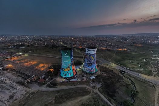 A stunning aerial view of the iconic Orlando Towers in Johannesburg at twilight, showcasing the vibrant cityscape.