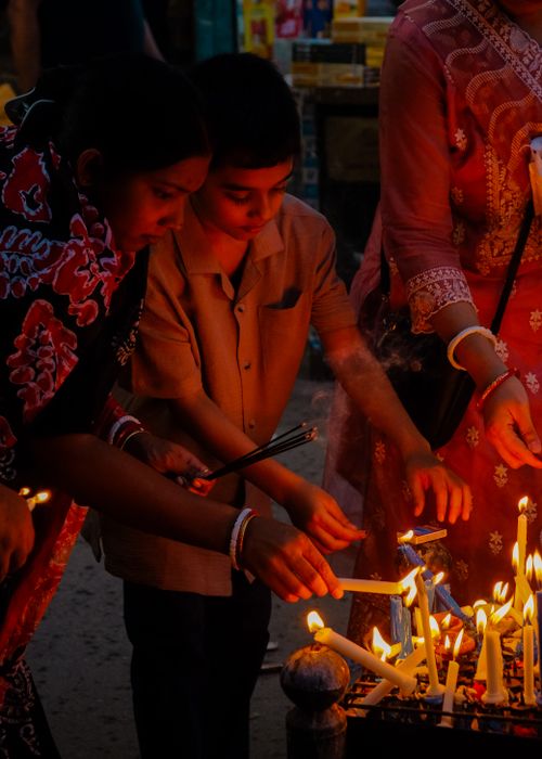 Free Children and adults participating in a candle lighting ceremony in Dhaka, Bangladesh, fostering cultural traditions. Stock Photo