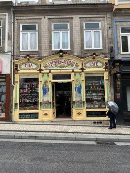Charming vintage coffee shop facade in Porto, Portugal, featuring intricate architectural details.