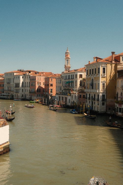 Free Serene view of Venice's historic canals with gondolas and classic architecture. Stock Photo