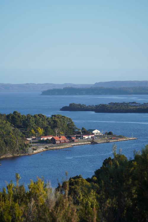 Free Beautiful view of Strahan harbor with lush greenery and calm waters in Tasmania. Stock Photo