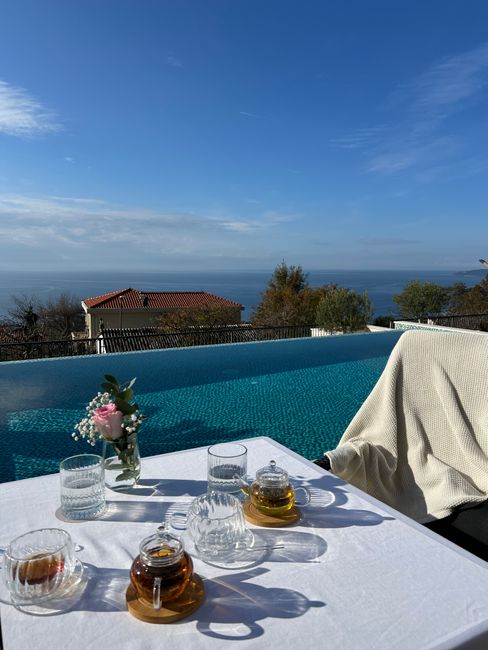 Enjoying a tranquil tea time by the pool with stunning Montenegro sea views, offering a peaceful atmosphere.
