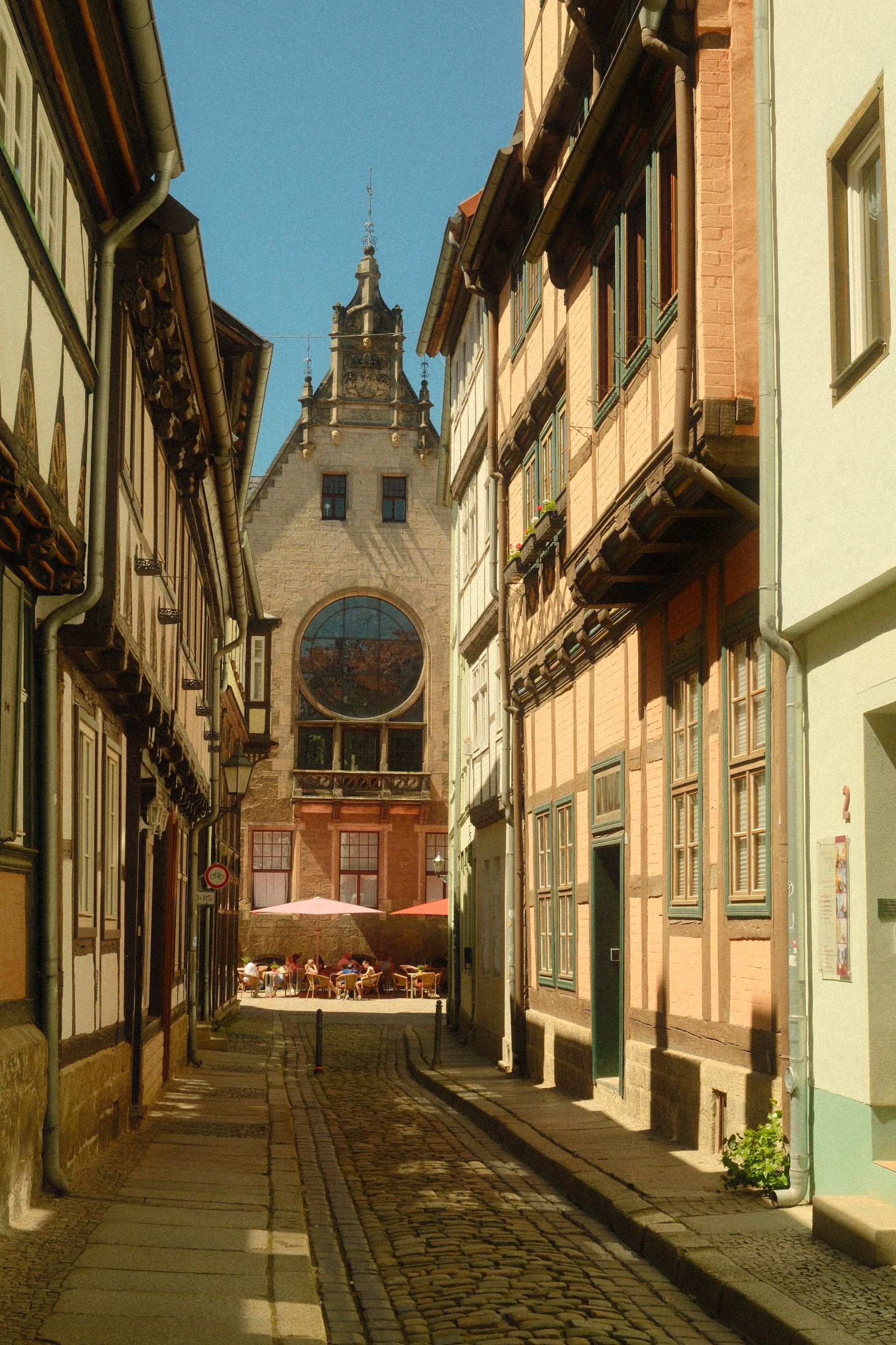 Historic street scene in Quedlinburg featuring half-timbered buildings and gothic architecture.