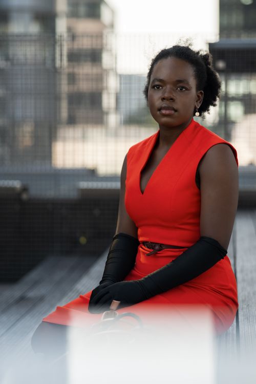 Free Stylish woman in red dress and black gloves posed outdoors in Düsseldorf. Stock Photo