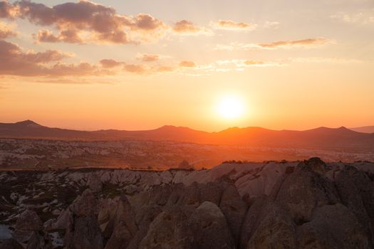 Capture of a breathtaking sunset over the rock formations in Cappadocia, Nevşehir, Türkiye.