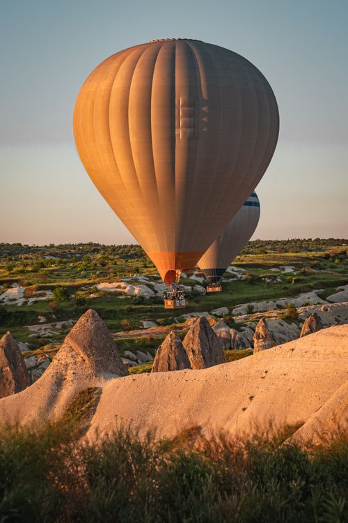 Free Breathtaking hot air balloon ride over the unique rock formations of Nevşehir, Türkiye at sunrise. Stock Photo