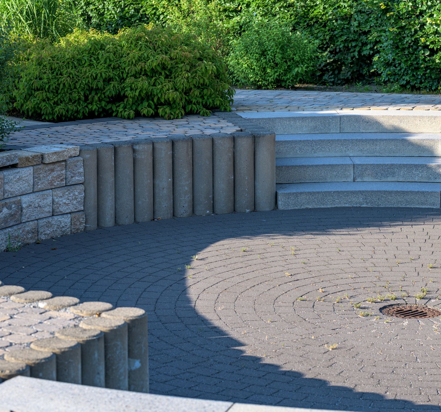 Elegant circular patio with stone steps and lush greenery, Coesfeld, Germany.