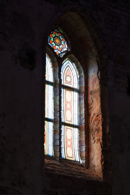 Free Colorful stained glass window in a historic brick cathedral in Kaliningrad, Russia. Stock Photo