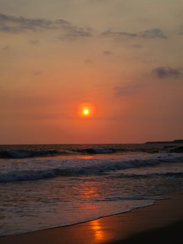 Vibrant sunset view over the ocean waves in Goa, India. Peaceful and mesmerizing seascape.