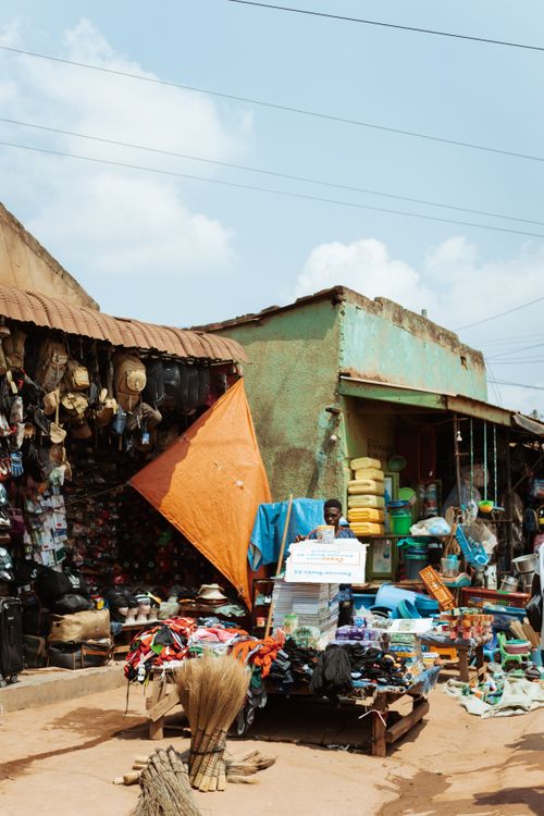 Free Outdoor market scene with various traditional goods on display under a clear sky. Stock Photo