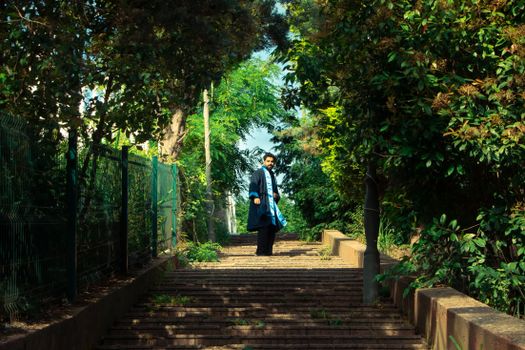 Graduate in a captivating forest setting, symbolizing success and new beginnings.