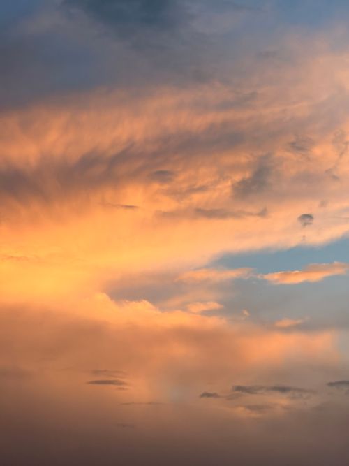 Free A captivating sunset with dramatic orange and blue clouds creating a stunning sky. Stock Photo