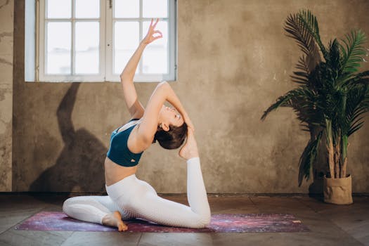 A woman practicing an elegant yoga pose indoors, promoting fitness and mindfulness.