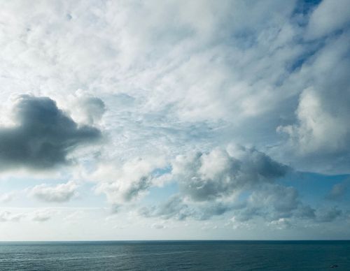Free Expansive view of clouds over a calm ocean, inspiring tranquility and openness. Stock Photo
